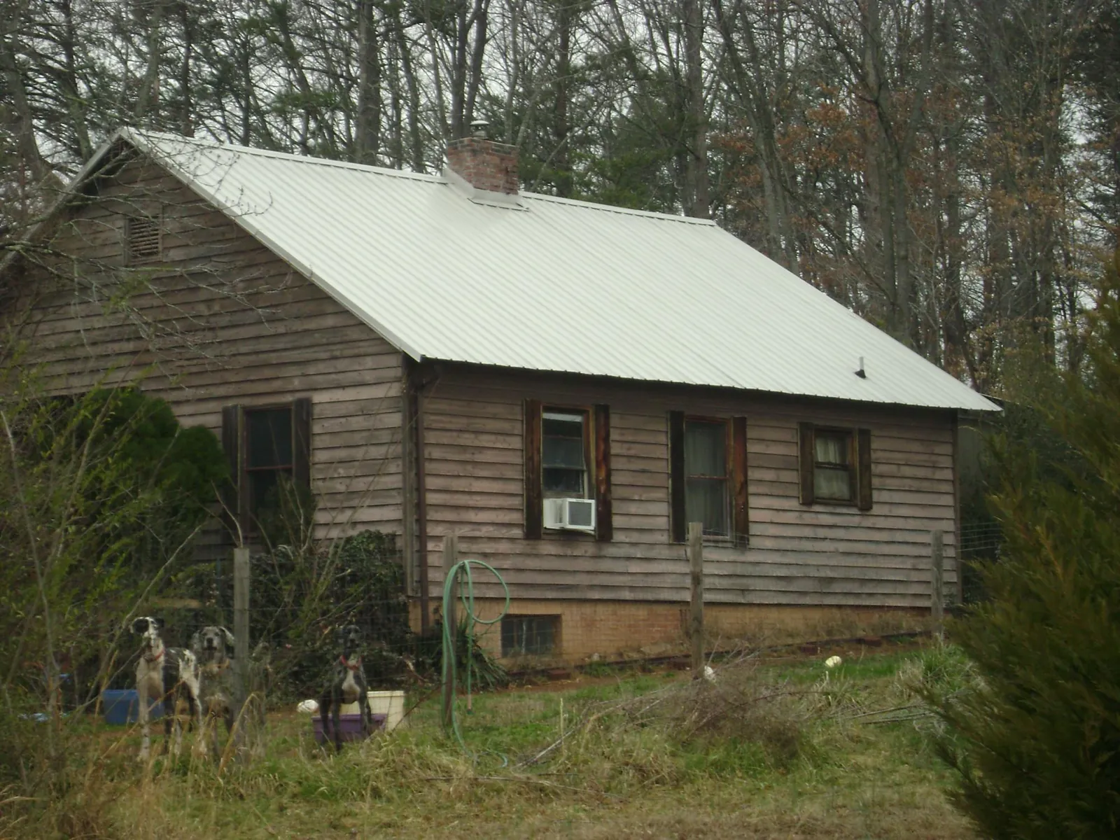 White metal roof on an old wood sided farmhouse, from a Metal Roof Installation job in Cromwell